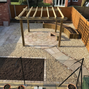 garden renovation with Sandstone Circle Paving, pergola and raised planter